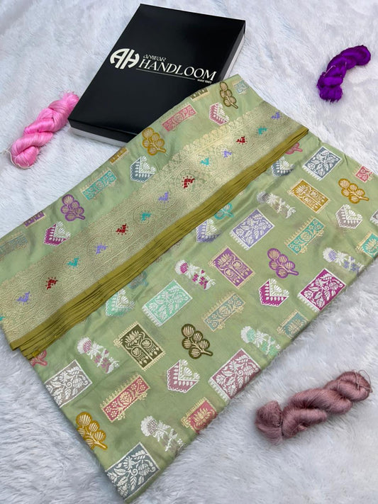 This is a sophisticated Katan Silk Handloom Saree, featuring an elegant pastel sage green base.