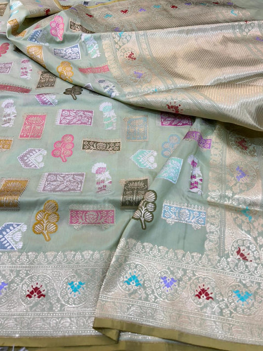 This is a sophisticated Katan Silk Handloom Saree, featuring an elegant pastel sage green base.