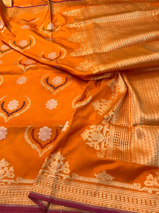 This exquisite Orange Pure Katan iktara Silk Banarasi Saree