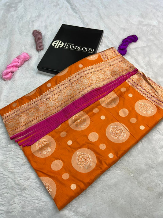 This Orange Banarasi Handloom Saree with gold zari and pink dori mina and edge on border
