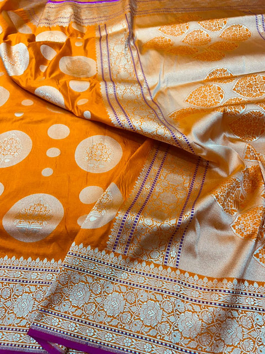 This Orange Banarasi Handloom Saree with gold zari and pink dori mina and edge on border